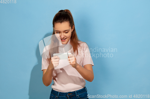 Image of Caucasian teen girl portrait isolated on blue studio background