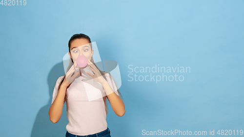 Image of Caucasian teen girl portrait isolated on blue studio background