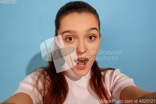 Image of Caucasian teen girl portrait isolated on blue studio background