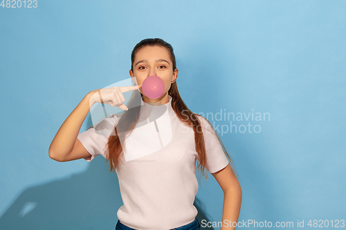 Image of Caucasian teen girl portrait isolated on blue studio background