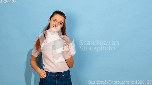 Image of Caucasian teen girl portrait isolated on blue studio background