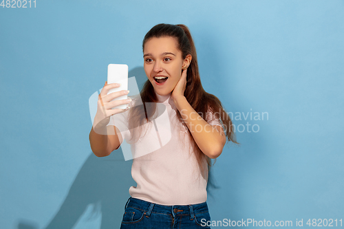 Image of Caucasian teen girl portrait isolated on blue studio background