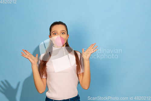 Image of Caucasian teen girl portrait isolated on blue studio background