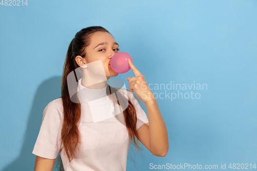 Image of Caucasian teen girl portrait isolated on blue studio background