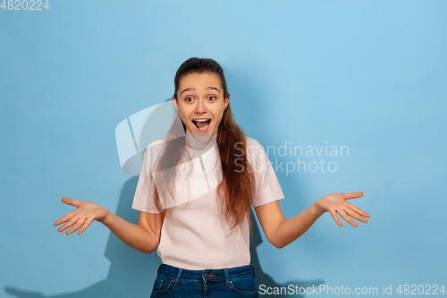 Image of Caucasian teen girl portrait isolated on blue studio background