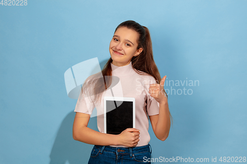 Image of Caucasian teen girl portrait isolated on blue studio background