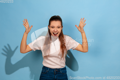 Image of Caucasian teen girl portrait isolated on blue studio background