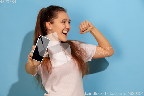 Image of Caucasian teen girl portrait isolated on blue studio background