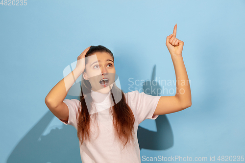 Image of Caucasian teen girl portrait isolated on blue studio background