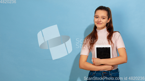 Image of Caucasian teen girl portrait isolated on blue studio background