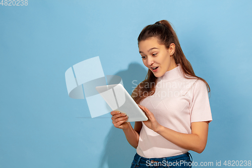 Image of Caucasian teen girl portrait isolated on blue studio background