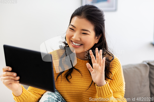 Image of woman with tablet pc having video call at home