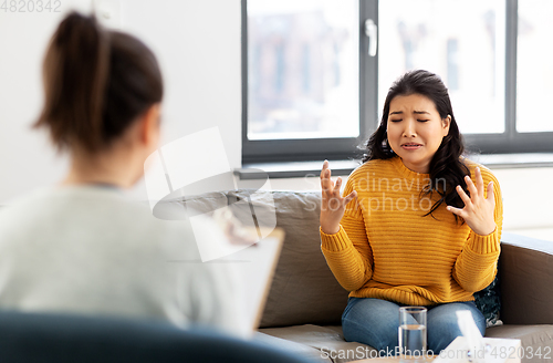 Image of woman patient and psychologist at psychotherapy