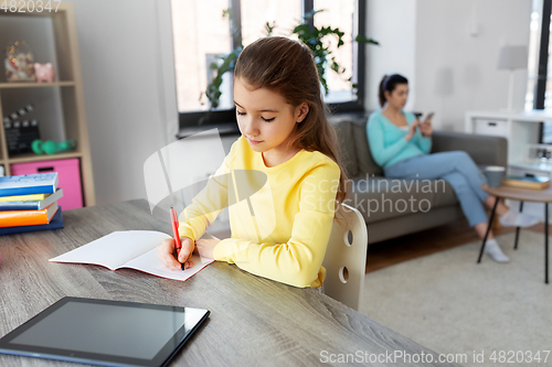 Image of student girl with tablet pc learning at home