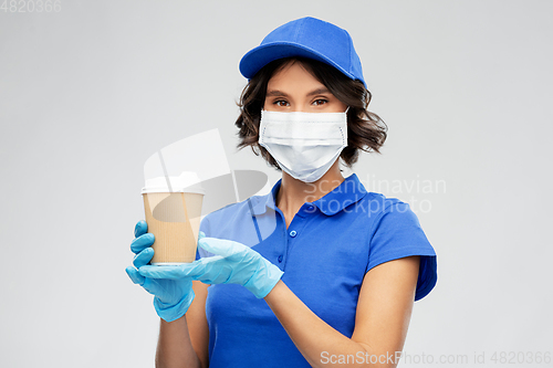 Image of saleswoman in face mask with takeaway coffee cup