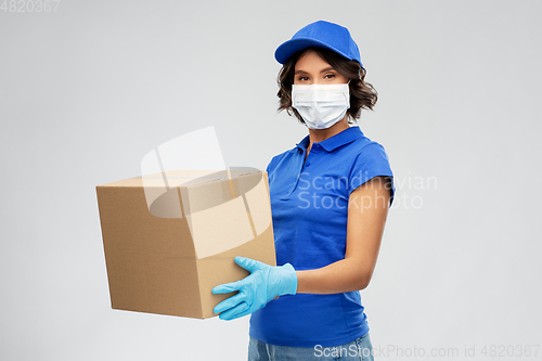 Image of delivery woman in face mask holding parcel box