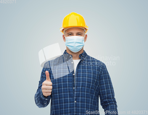 Image of male worker in safety helmet wearing face mask