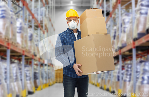 Image of worker in respirator mask with boxes at warehouse