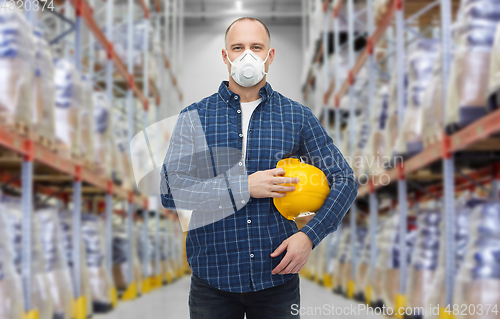 Image of male worker wearing respirator mask at warehouse