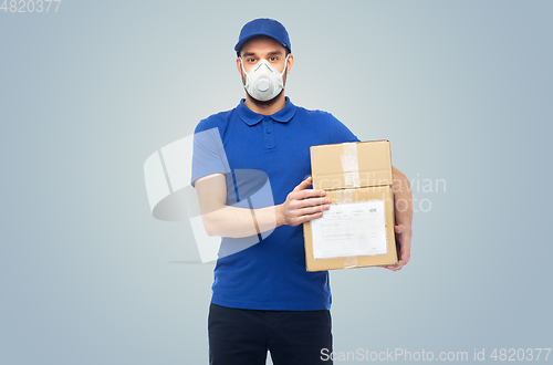 Image of delivery man with parcel box in respirator