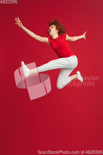 Image of Caucasian woman\'s portrait isolated over red studio background with copyspace