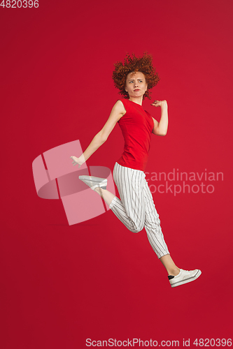 Image of Caucasian woman\'s portrait isolated over red studio background with copyspace