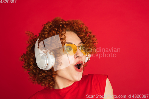 Image of Caucasian woman\'s portrait isolated over red studio background with copyspace