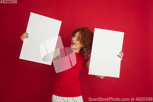 Image of Caucasian woman\'s portrait isolated over red studio background with copyspace