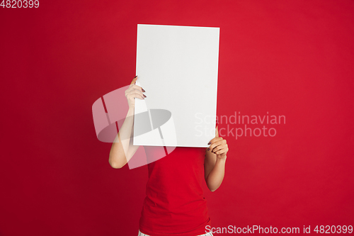 Image of Caucasian woman\'s portrait isolated over red studio background with copyspace