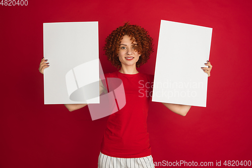 Image of Caucasian woman\'s portrait isolated over red studio background with copyspace