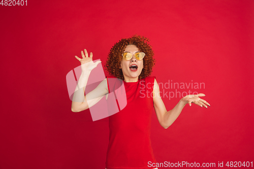Image of Caucasian woman\'s portrait isolated over red studio background with copyspace