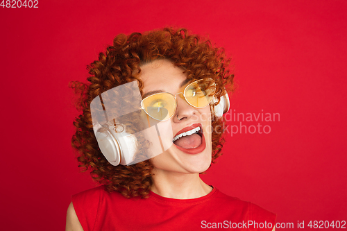 Image of Caucasian woman\'s portrait isolated over red studio background with copyspace