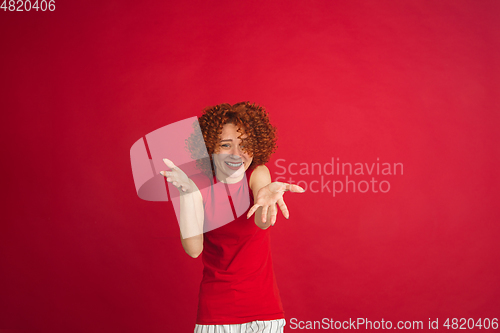 Image of Caucasian woman\'s portrait isolated over red studio background with copyspace