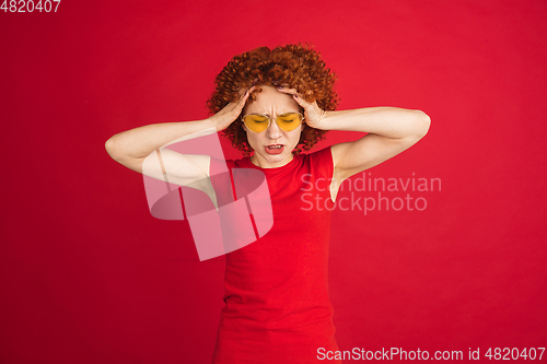 Image of Caucasian woman\'s portrait isolated over red studio background with copyspace