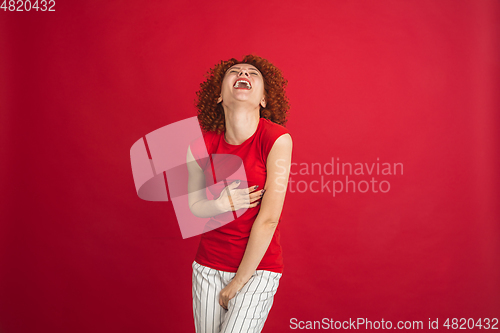 Image of Caucasian woman\'s portrait isolated over red studio background with copyspace