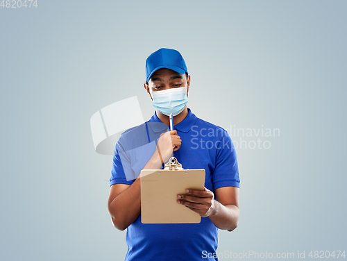 Image of delivery man in face mask with clipboard