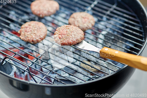 Image of close up of meat cutlets roasting on grill