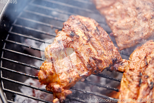 Image of close up of barbecue meat roasting on grill