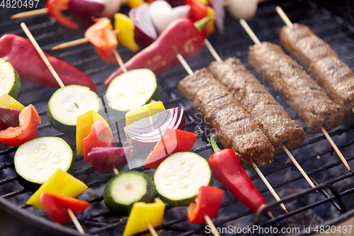 Image of close up of barbecue kebab meat roasting on grill