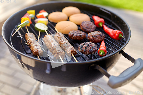 Image of barbecue kebab meat and vegetables on grill