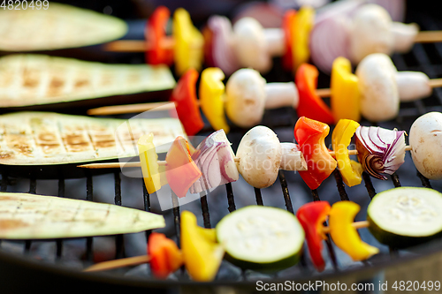 Image of vegetables and mushrooms roasting on brazier grill