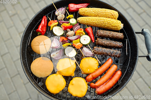 Image of barbecue kebab meat and vegetables on grill