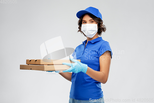 Image of delivery woman in face mask with pizza boxes