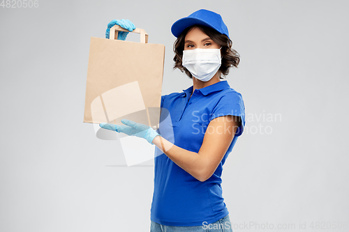 Image of delivery woman in face mask with food in paper bag