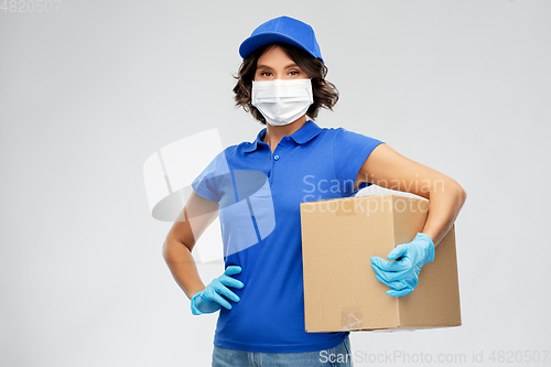 Image of delivery woman in face mask holding parcel box