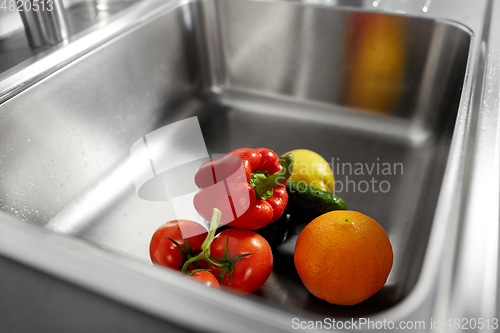 Image of fruits and vegetables in kitchen sink