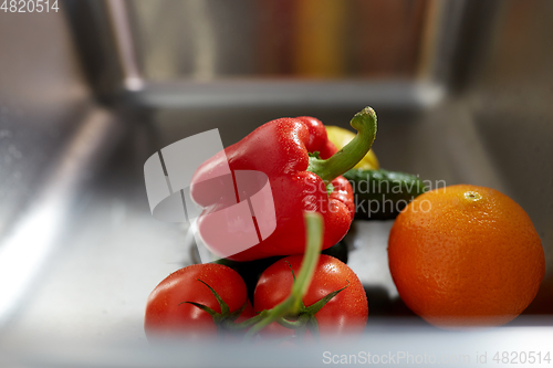 Image of close up of fruits and vegetables in kitchen sink