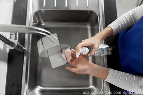 Image of doctor or nurse washing hands with liquid soap