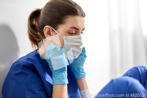 Image of sad doctor or nurse in protective face mask