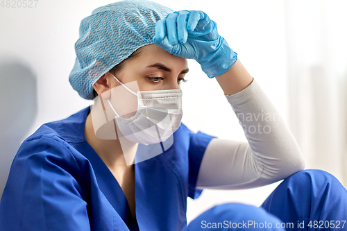 Image of sad doctor or nurse in protective face mask